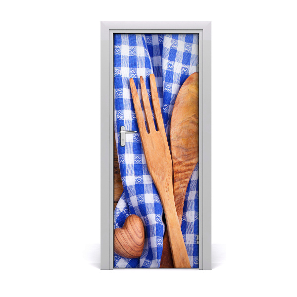 Fototapeta na dvere Drevený príbor na modrom obruse
