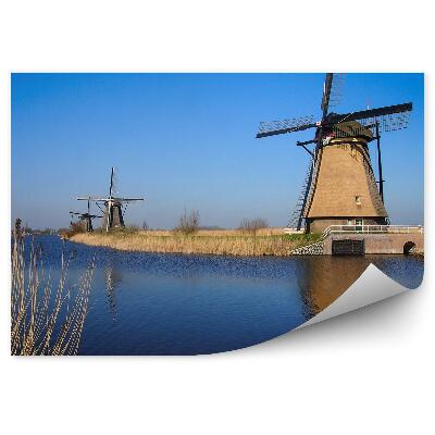 Fototapeta na stenu Niz mlinov na veter ob reki