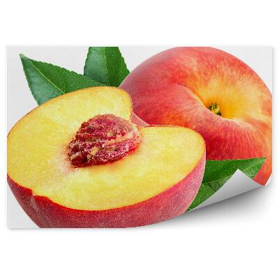 Fototapeta na stenu Broskyňa kôstka polovica zrelého ovocia zelené listy