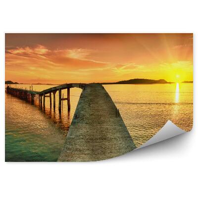 Fototapeta Východ slnka nad vodou a mostom