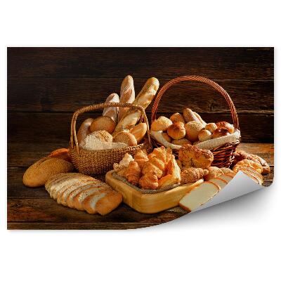 Fototapeta na stenu Rôzne druhy chleba v prútenom košíku na starom drevenom podklade