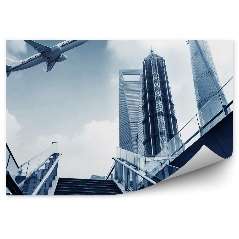 Fototapeta na stenu Lietadlo letiace nad mestom schody