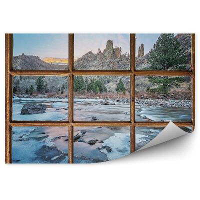Fototapeta Staré okno s výhľadom na hory a zamrznutý potok