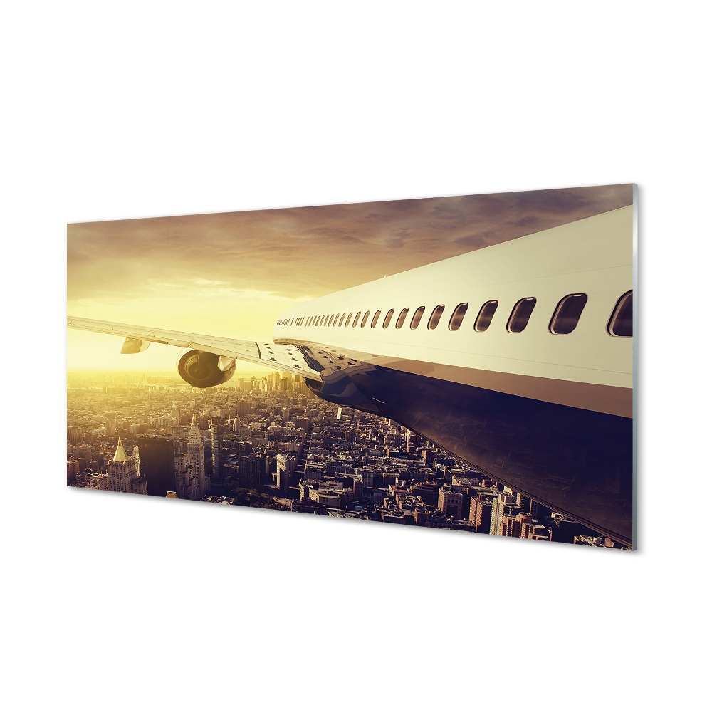 Obraz na skle Lietadlo nad budovami mesta