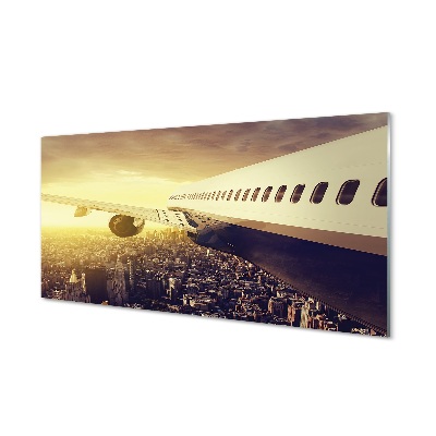 Obraz na skle Lietadlo nad budovami mesta